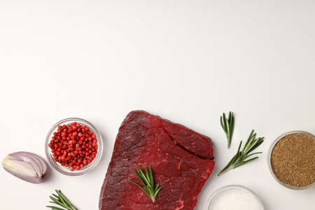 Concept of cooking with raw steak on white backgroundの写真素材