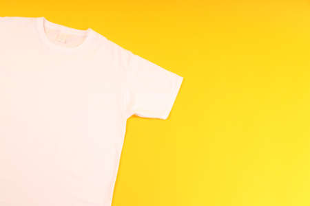 White t-shirt with space for print on yellow backgroundの写真素材