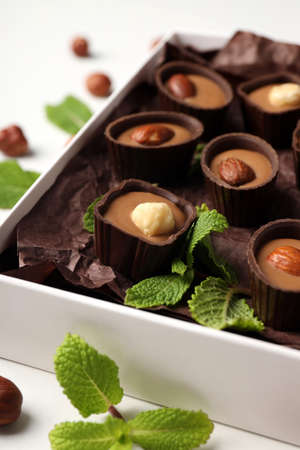 Concept of sweets with chocolate candies on white backgroundの写真素材