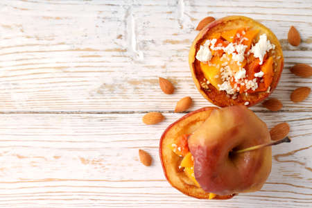Concept of tasty food with baked apples on white wooden tableの写真素材