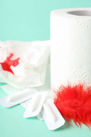 Concept of healthcare with hemorrhoids accessories on mint background