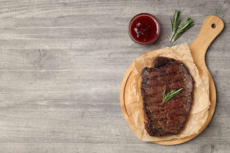 Concept of tasty food with beef steak on gray wooden backgroundの写真素材