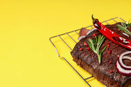 Concept of tasty food with beef steak on yellow backgroundの写真素材
