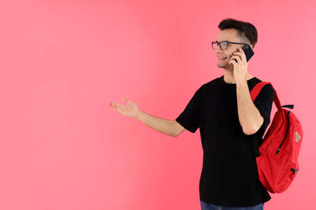 Attractive young delivery man on blue background