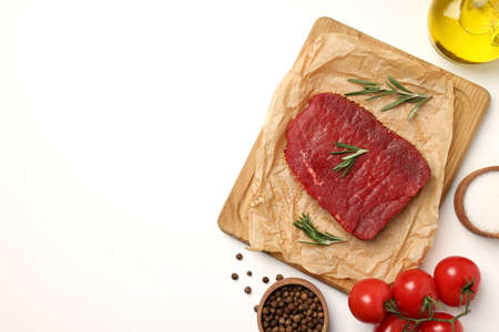 Concept of tasty food with raw beef steak on white backgroundの写真素材