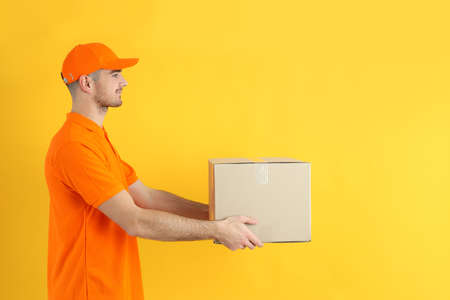 Delivery guy hold box on yellow background