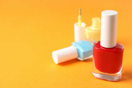 Nail polish on orange background, close up