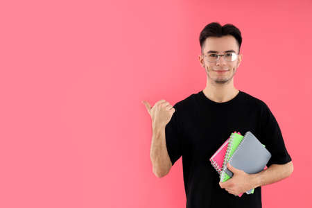 Attractive young delivery man on blue background