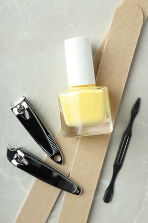 Concept of nail care with manicure accessories on light textured background