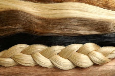 Different color female hair on whole background, close up