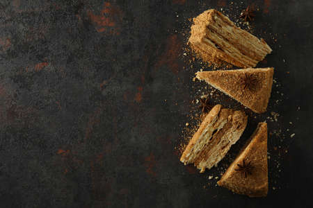 Pieces of honey cake on dark textured backgroundの写真素材