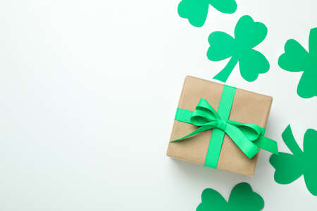 Clover leaves and gift box on white backgroundの写真素材