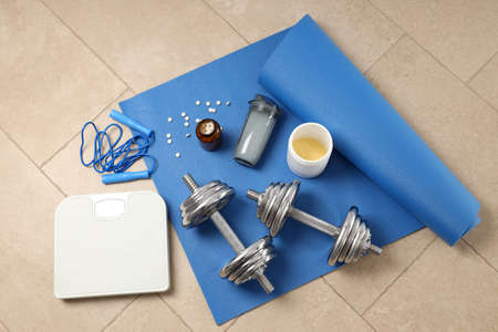 Fitness or sport accessories on fitness mat on floorの写真素材