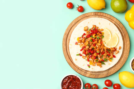 Concept of tasty food with taco on mint backgroundの写真素材