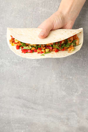 Concept of tasty food with taco on gray textured backgroundの写真素材