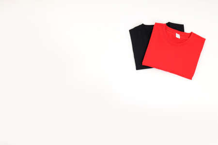 Folded black and red t-shirts isolated on white backgroundの写真素材