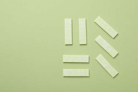 Chewing gum on green background, space for textの写真素材