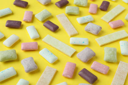 Chewing or bubble gum on yellow background
