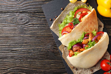 Concept of tasty food with pita with chicken, space for textの写真素材