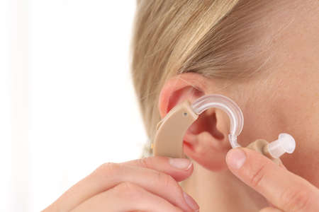 Concept of health care with hearing aid, close up
