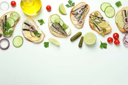 Concept of tasty snack with sandwiches with sprats on white backgroundの写真素材