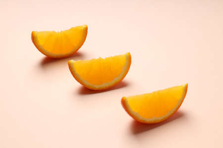 Orange slices on beige background, close upの写真素材