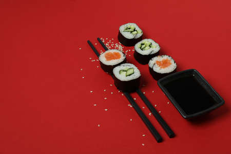 Concept of tasty food with maki on red backgroundの写真素材