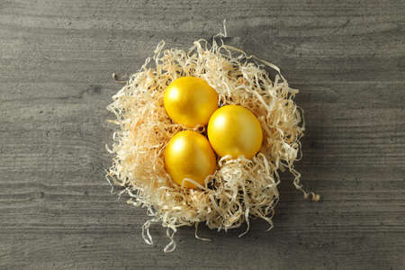 Nest with Easter eggs on wooden background, top viewの写真素材