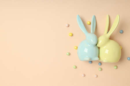 Easter bunnies on beige background, space for textの写真素材