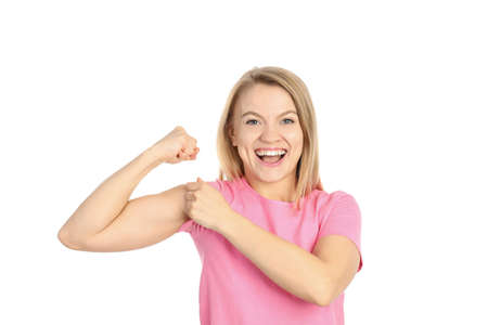 Young woman showing biceps, isolated on white background