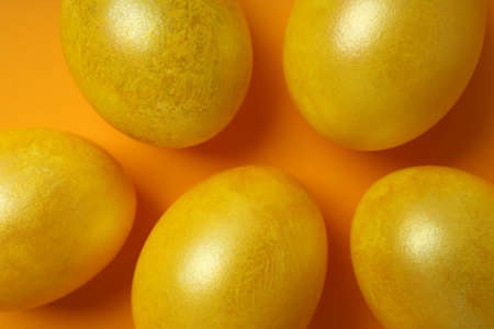 Easter eggs on orange background, close up