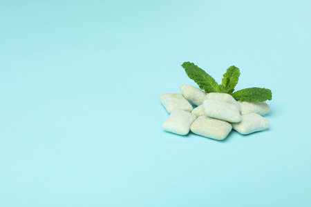 Chewing or bubble gum and mint on blue backgroundの写真素材