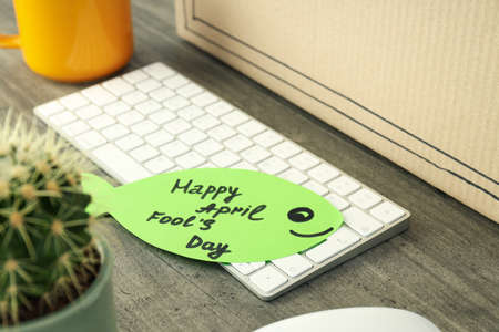 Concept of April Fool's Day on gray wooden table