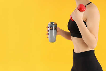 Concept of sports nutrition on yellow background, space for text