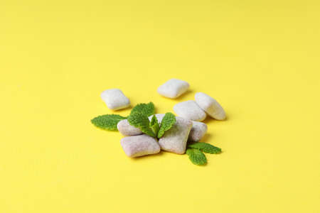 Chewing or bubble gum on yellow background