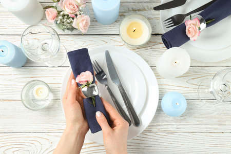 Beautiful table setting with aroma candles, top view