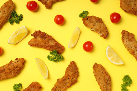 Concept of tasty food with Chicken strips on yellow backgroundの写真素材