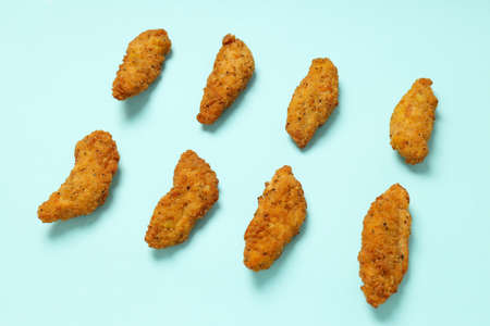 Concept of tasty food with Chicken strips on blue backgroundの写真素材