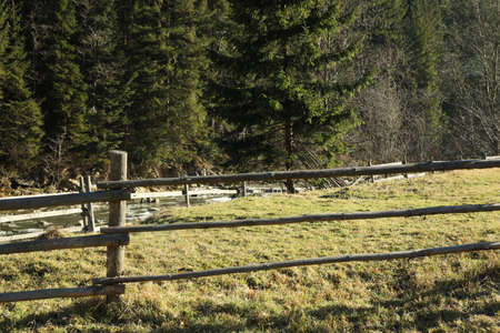 Wooden fence in Carpathian mountains in sunny dayの写真素材
