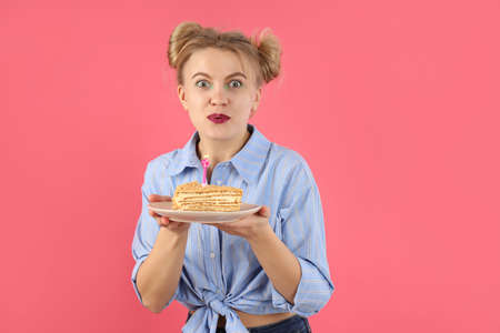 Concept of Happy Birthday with young woman on pink background