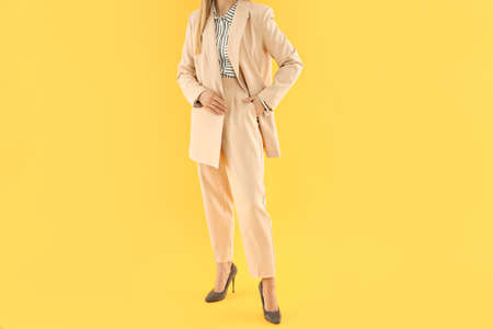 Concept of business with young attractive business woman on yellow backgroundの写真素材