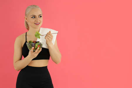 Concept of healthy lifestyle with sporty woman on pink backgroundの写真素材