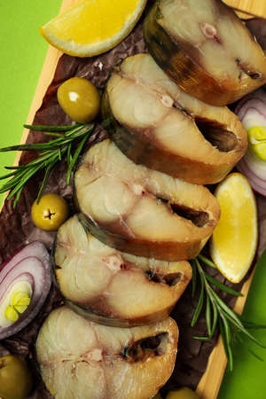 Concept of tasty food with smoked mackerel on green backgroundの写真素材