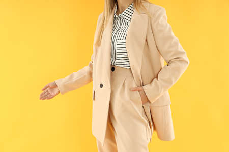 Concept of business with young attractive business woman on yellow backgroundの写真素材