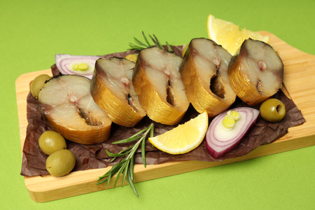 Concept of tasty food with smoked mackerel on green backgroundの写真素材