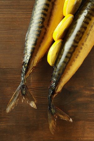 Concept of tasty food with smoked mackerel on wooden backgroundの写真素材