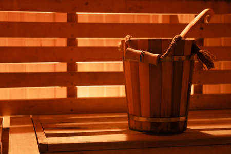 A wooden bucket stands in a modern comfortable saunaの写真素材