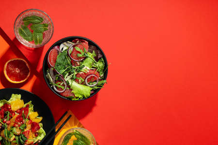 Concept of tasty food, salad with red orange, space for textの写真素材