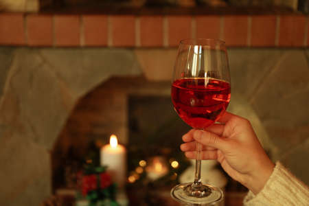 Composition with glass of wine in cozy winter eveningの写真素材