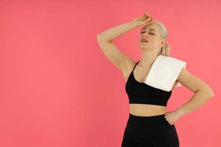 Concept of healthy lifestyle with sporty woman on pink backgroundの写真素材